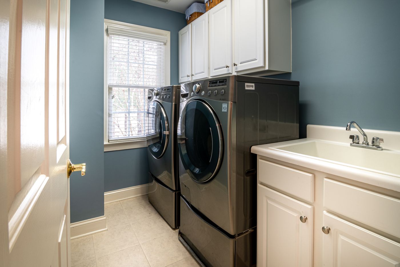 LG front load washing machine and dryer installed in a home laundry room